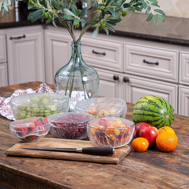 Assorted sizes of elastic food covers stretching over various containers, perfect for food preservation