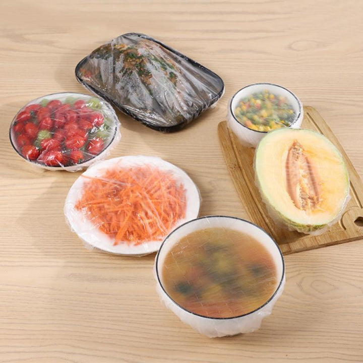 Close-up of a clear elastic food cover tightly sealed over a plate, showing reusable plastic wrap alternative