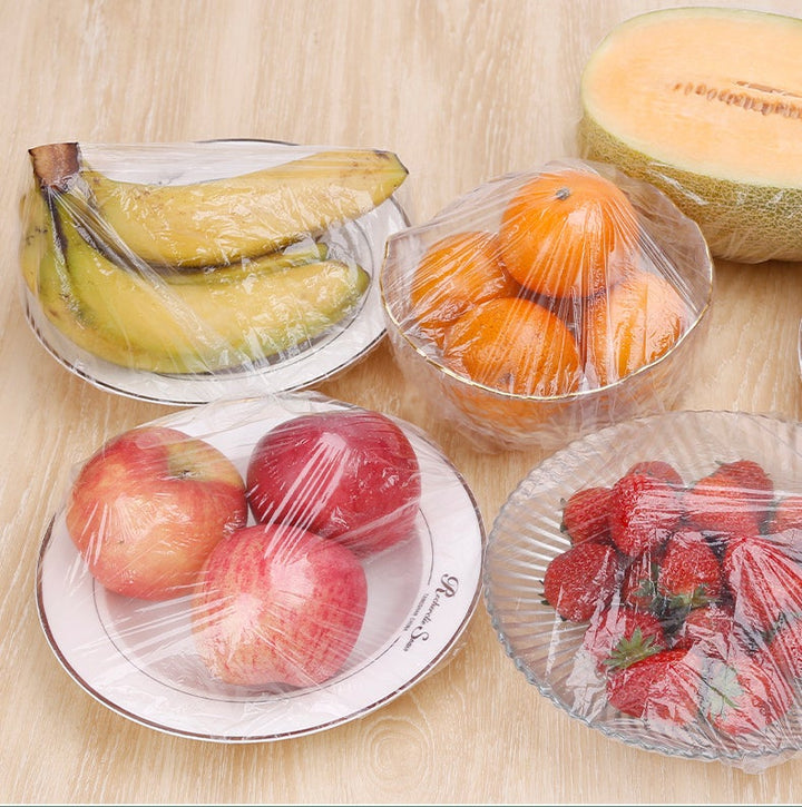 Close-up of a clear disposable food cover stretched over a bowl, highlighting its universal fit and fresh-keeping use.