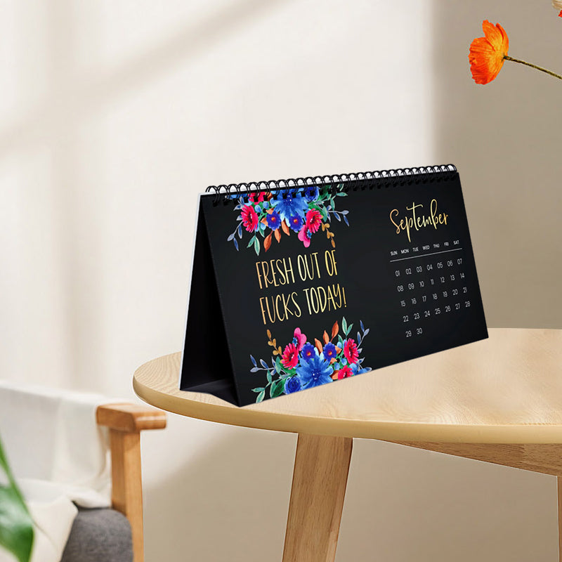 Stack of new 2025 Wall & Desk Calendars, ready for gifting, featuring diverse inspirational quotes