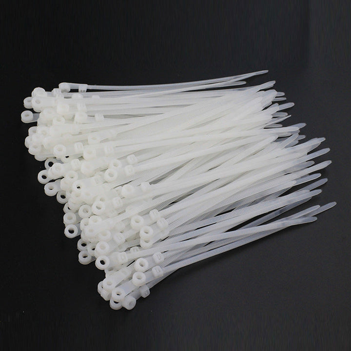 Diagram illustrating how to use self-locking nylon cable ties for secure wall-mounted cables