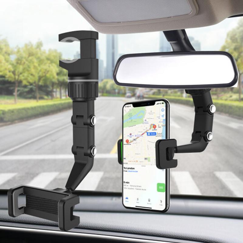 Universal car phone mount firmly gripping a smartphone, installed on a rear view mirror in an automobile
