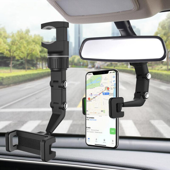 Universal car phone mount firmly gripping a smartphone, installed on a rear view mirror in an automobile