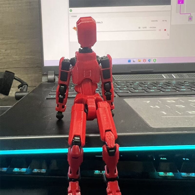 Child's hand interacting with a 3D printed robot toy, demonstrating its movable joints for play