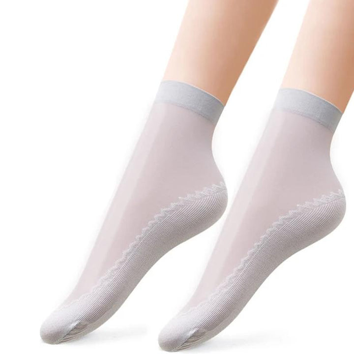Detail of the anti-slip silicone dots on the heel of a women's silky sock, preventing slippage