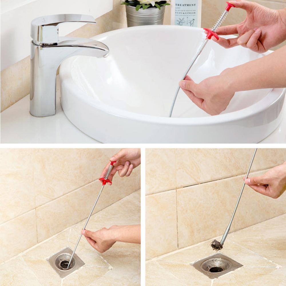 Flexible 60cm drain cleaner tool next to a clogged kitchen sink drain opening