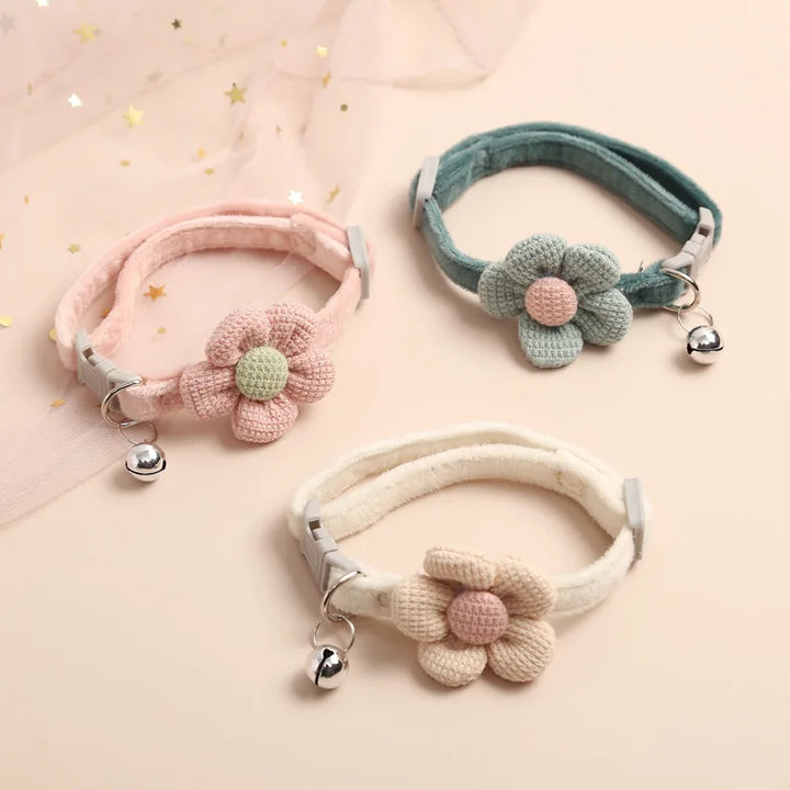 "Adjustable cat collar with floral pattern and bell, featuring earth tones and pastels for style and comfort."