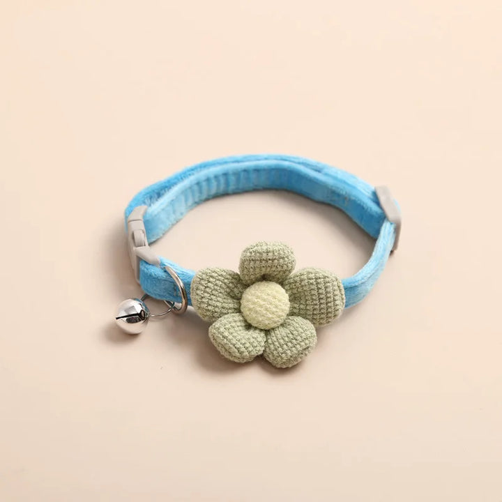 "Adjustable cat collar with floral pattern and bell, featuring earth tones and pastels for style and comfort."