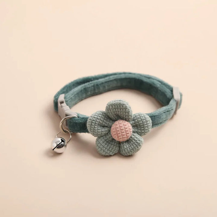 "Adjustable cat collar with floral pattern and bell, featuring earth tones and pastels for style and comfort."