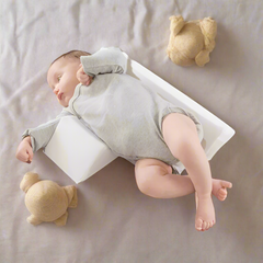 Anti-Roll Adjustable Memory Foam Baby Pillow in Pink, side-sleeper support, gentle and breathable design for newborns.