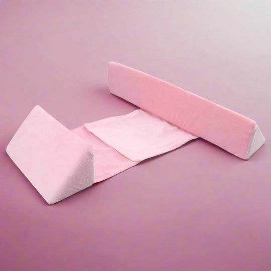 Anti-Roll Adjustable Memory Foam Baby Pillow in Pink, side-sleeper support, gentle and breathable design for newborns.