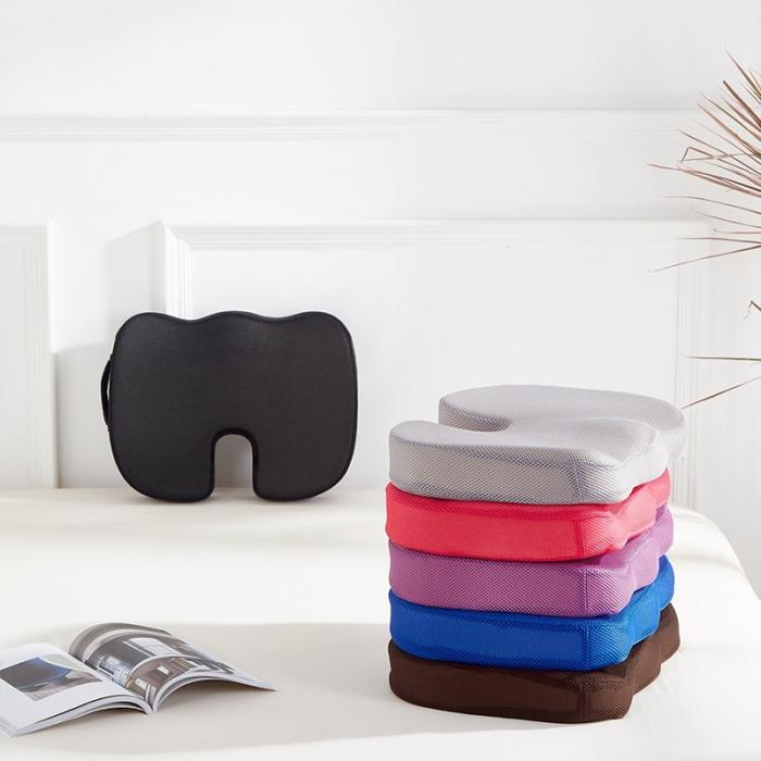 "Coccyx cushion with U-shape cutout, gray memory foam for tailbone pain relief, ergonomic design, enhances sitting comfort."