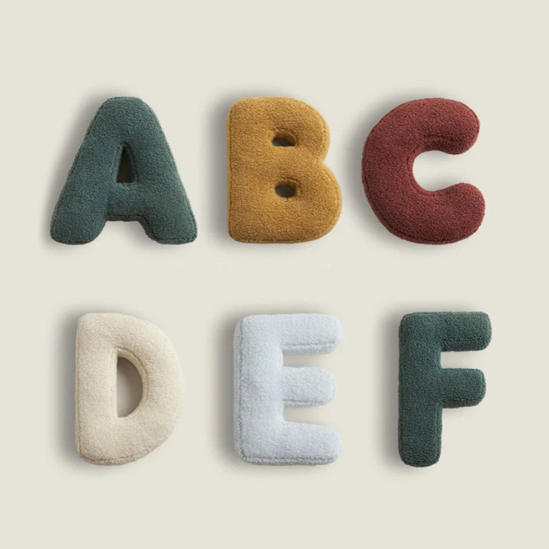 "Colorful alphabet cushion with cotton cover, ideal for home decoration or kids' rooms, adds playful elegance and comfort."