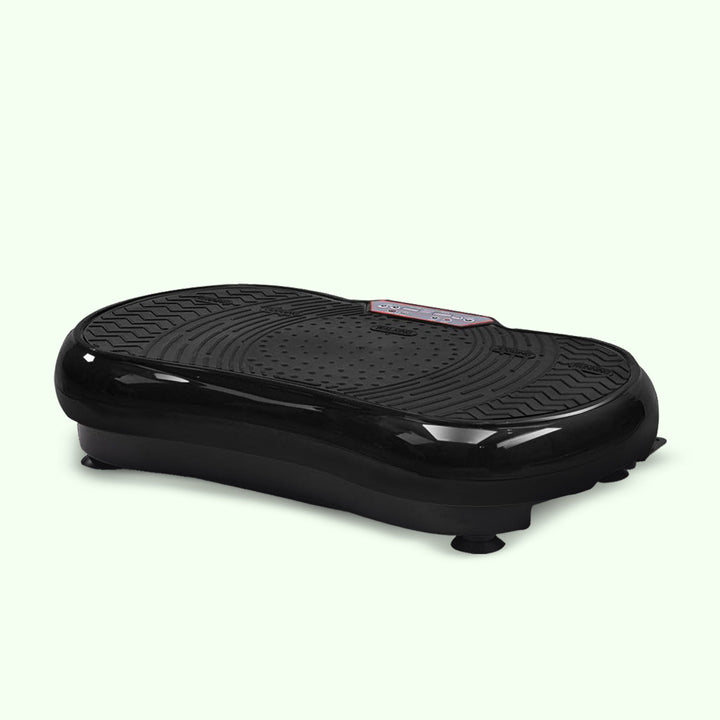 Compact home vibration exercise platform in black with detachable resistance bands, non-slip surface, and remote control.