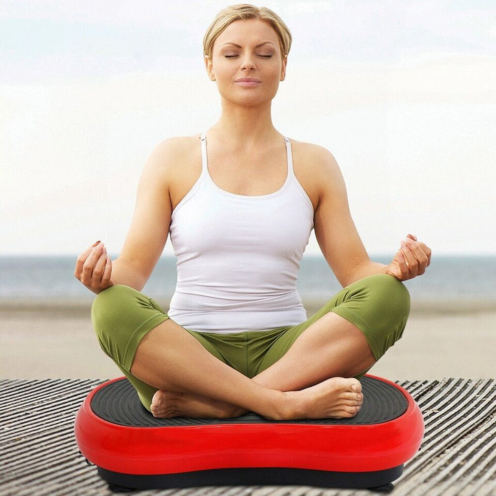 Compact home vibration exercise platform in black with detachable resistance bands, non-slip surface, and remote control.