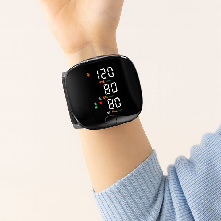 Compact smart wrist blood pressure monitor with a large LCD, sleek design, precise readings, ideal for health tracking.