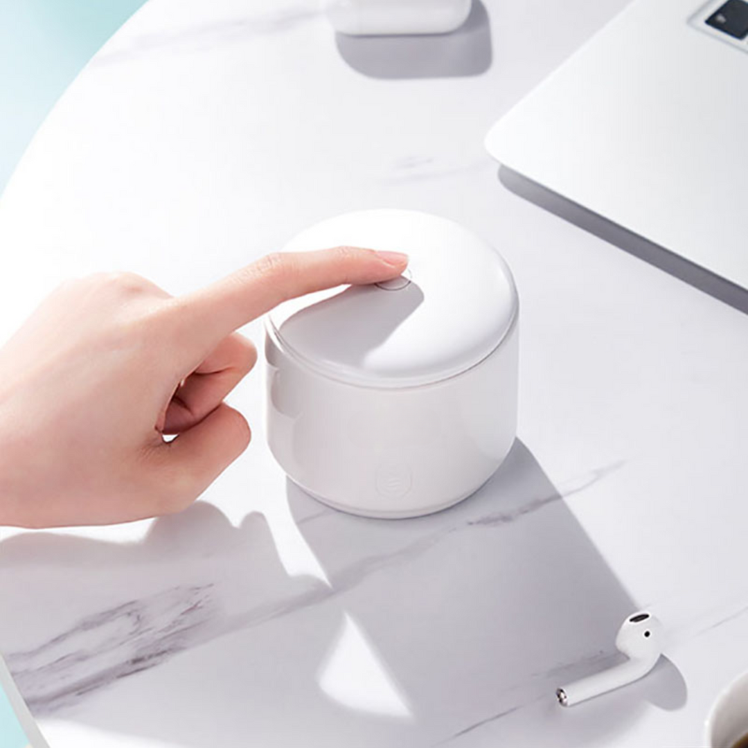 "Compact ultrasonic cleaner with UV lights, ideal for jewelry and watches, featuring a sleek design and deep cleaning technol