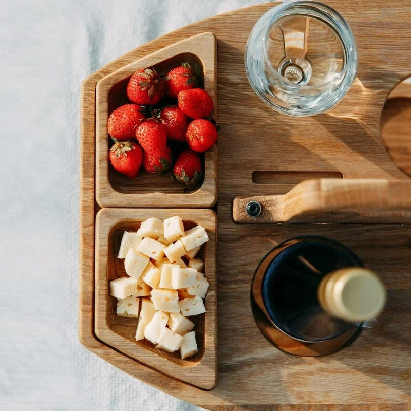 Compact wooden picnic wine table with compartments for snacks and wine, featuring a foldable, elegant design for outdoor gath