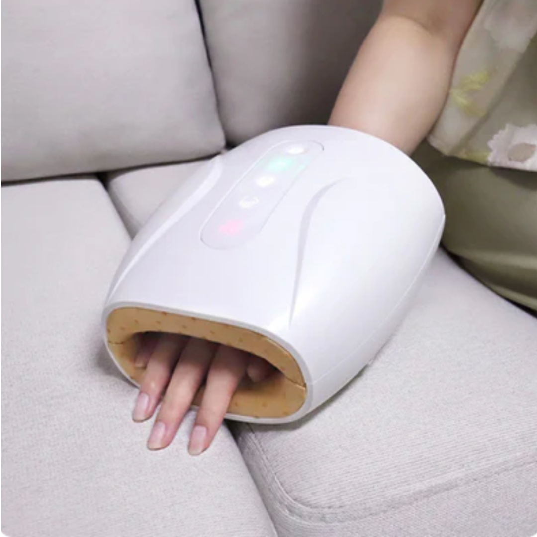Cordless USB hand massager with white durable exterior, soft cushioning, offering heat and compression for hand relaxation.