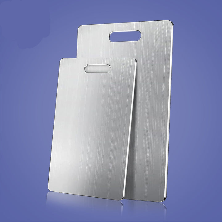 "Durable, bacteria-resistant stainless steel cutting board on countertop, non-porous surface perfect for hygienic food prep."