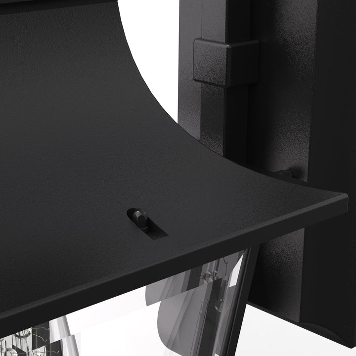Elegant matte black outdoor wall light with glass shade, weatherproof; perfect for enhancing entrance ambiance and style.