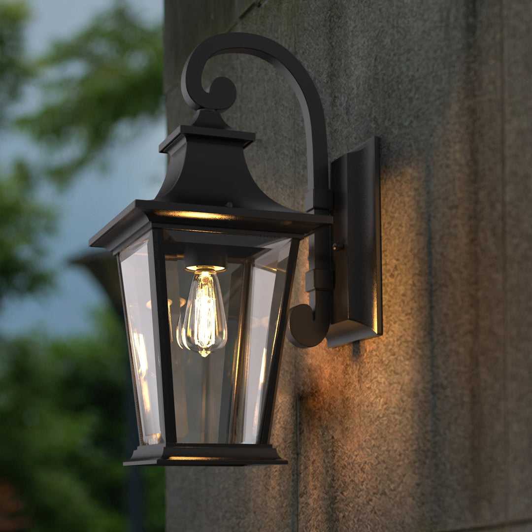 Elegant matte black outdoor wall light with glass shade, weatherproof; perfect for enhancing entrance ambiance and style.