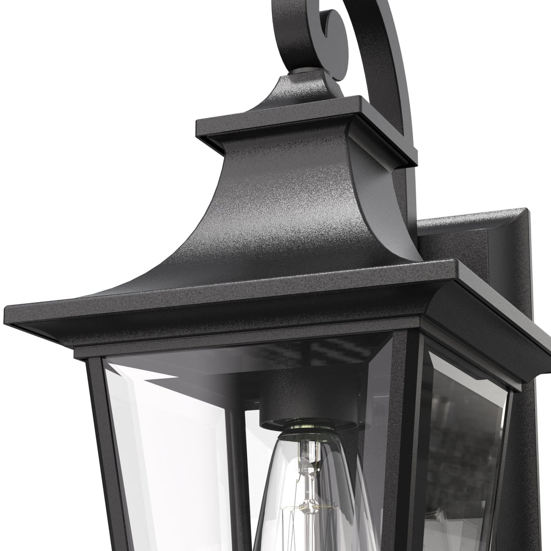 Elegant matte black outdoor wall light with glass shade, weatherproof; perfect for enhancing entrance ambiance and style.