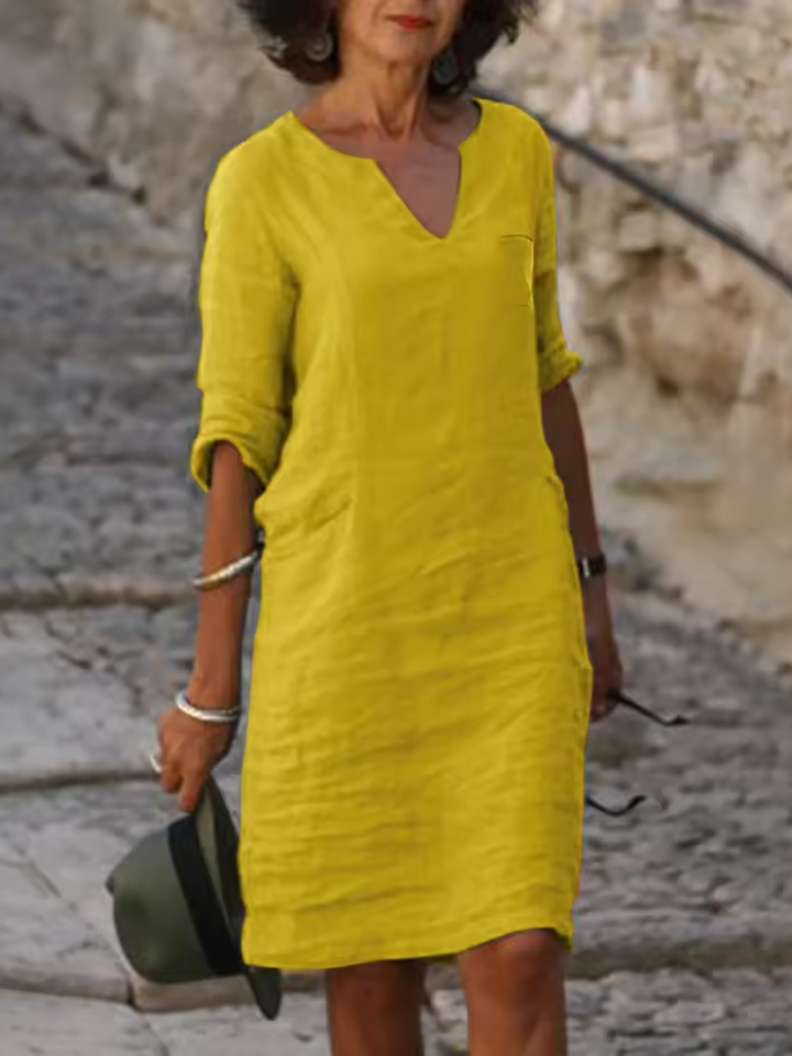 Elegant slim fit V-neck cotton linen dress with mid sleeves, perfect for warm weather. Shop women's dresses for all occasions