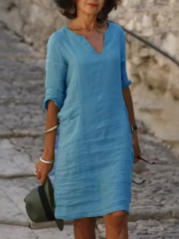 Elegant slim fit V-neck cotton linen dress with mid sleeves, perfect for warm weather. Shop women's dresses for all occasions