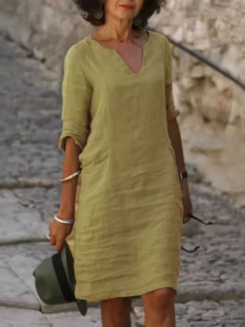 Elegant slim fit V-neck cotton linen dress with mid sleeves, perfect for warm weather. Shop women's dresses for all occasions