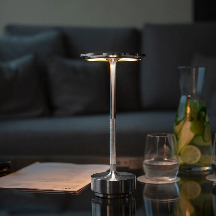"Elegant wireless table lamp with sleek curves, gold finish; perfect for versatile ambient lighting on any table or desk."