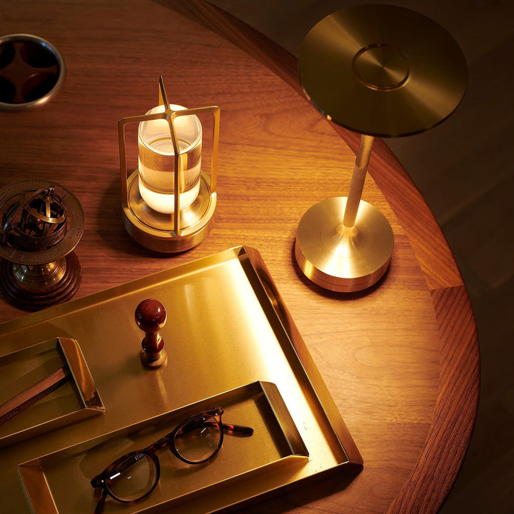 "Elegant wireless table lamp with sleek curves, gold finish; perfect for versatile ambient lighting on any table or desk."