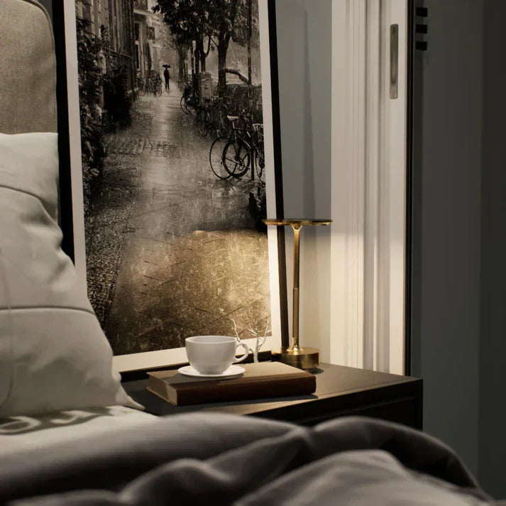 "Elegant wireless table lamp with sleek curves, gold finish; perfect for versatile ambient lighting on any table or desk."