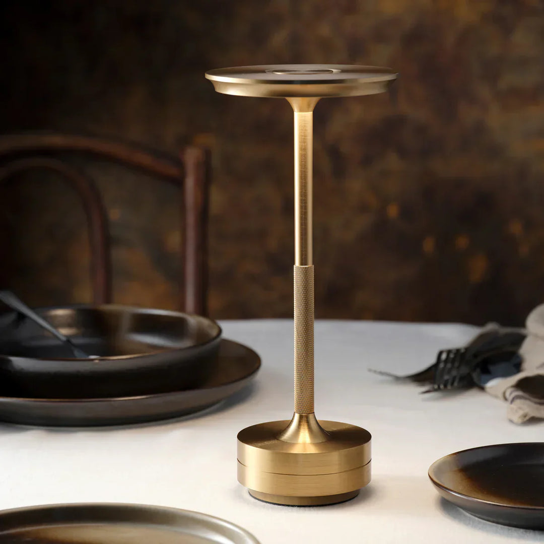 "Elegant wireless table lamp with sleek curves, gold finish; perfect for versatile ambient lighting on any table or desk."