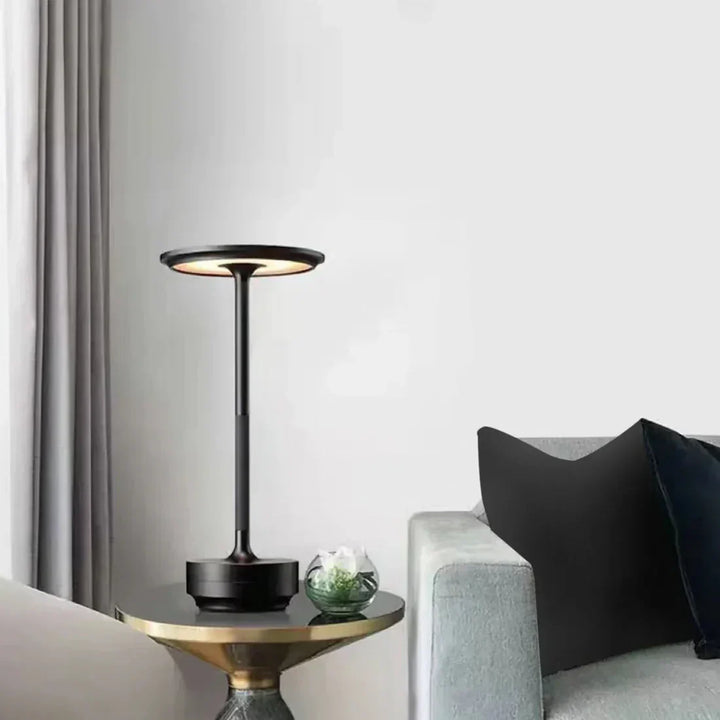 "Elegant wireless table lamp with sleek curves, gold finish; perfect for versatile ambient lighting on any table or desk."