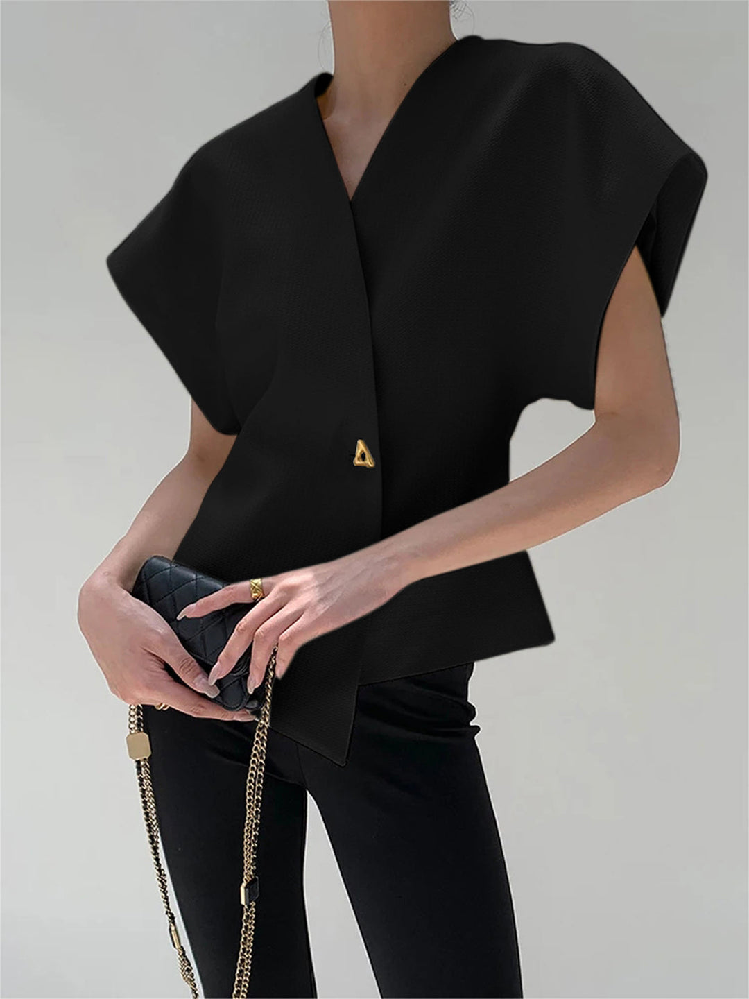 "Elegant women's V-neck blouse with buttons, tailored fit, chic button-down design, ideal for versatile stylish outfits."