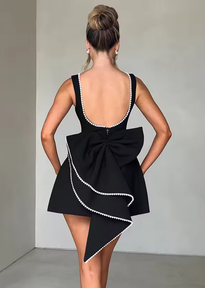 Elegant women's mini dress with pearl embellishments, structured fit, in black or white, ideal for evening events and occasio