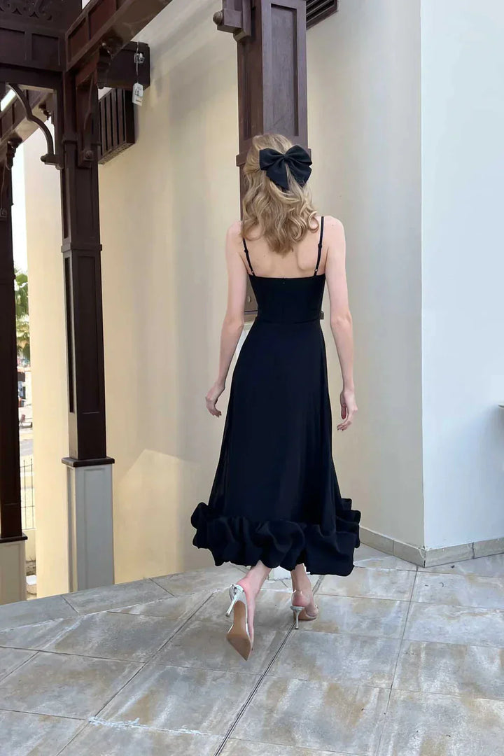 Elegant women's ruffled chiffon midi dress with spaghetti straps and ruffled hem, perfect for day and night.