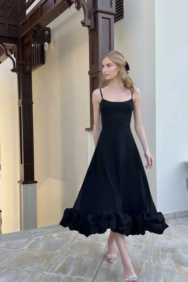 Elegant women's ruffled chiffon midi dress with spaghetti straps and ruffled hem, perfect for day and night.