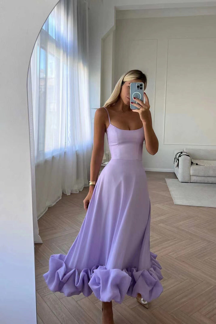 Elegant women's ruffled chiffon midi dress with spaghetti straps and ruffled hem, perfect for day and night.