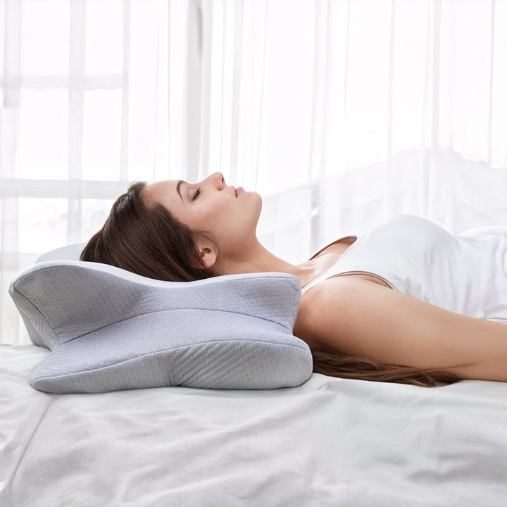 "Ergonomic butterfly-shaped memory foam pillow offering neck support, shown in stylish blue with breathable fabric design."