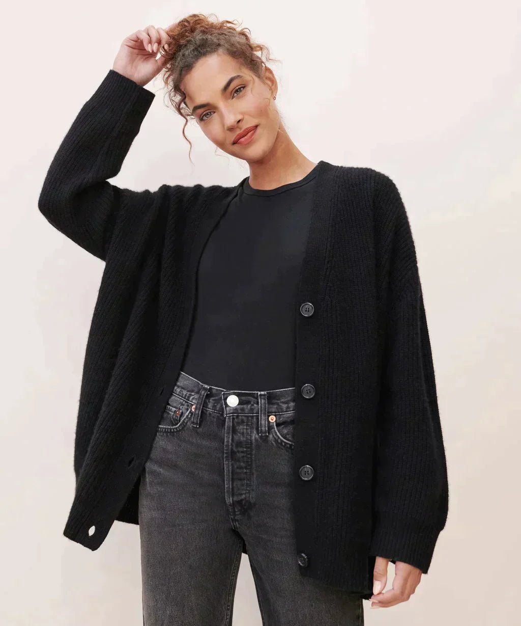 Front view of a soft, stylish women's cashmere cardigan in beige, showcasing its elegant, timeless silhouette for layering.