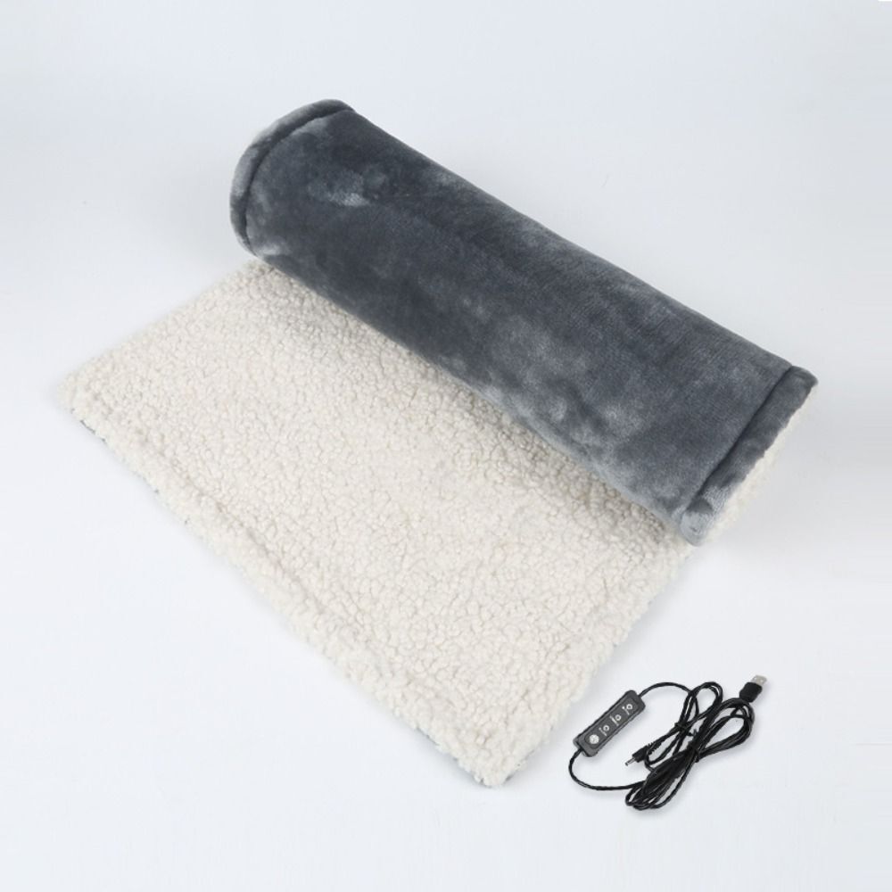 "Grey and pink flannel heated seat cushion, cozy and stylish, perfect for home, office, or travel comfort and warmth."