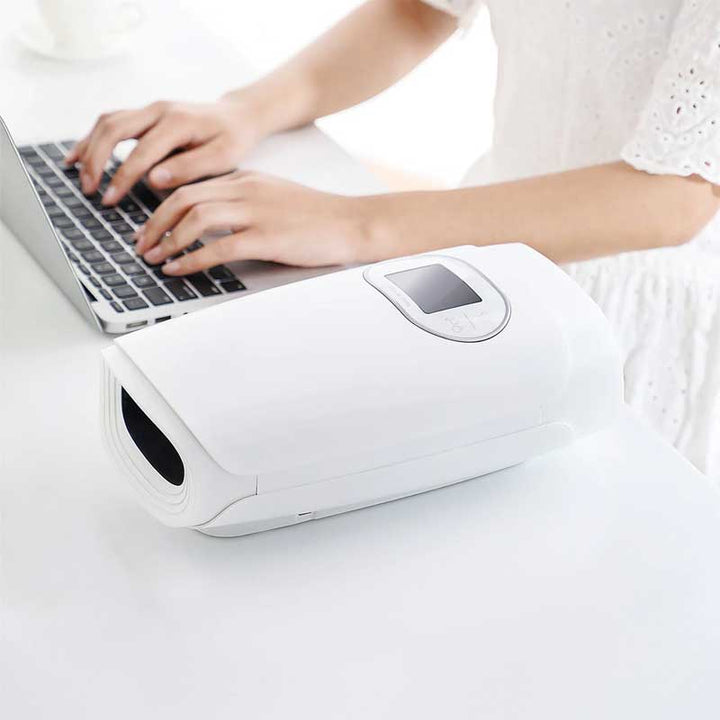 "Hand massager with heat and compression, beige, offers versatile relief with acupressure for hand wellness and relaxation."