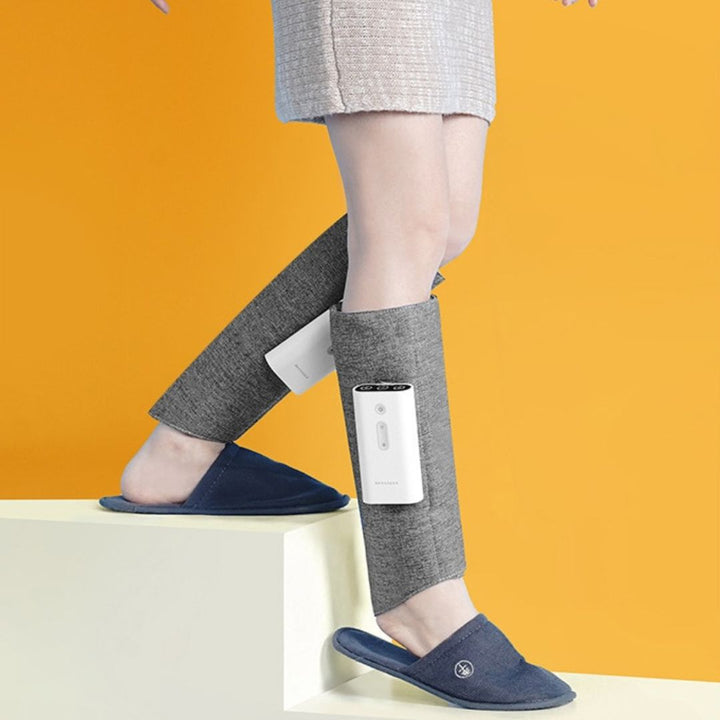 "Heated leg massager wraps around calves and ankles, shown in use. Provides soothing heat and customizable massage for relaxa