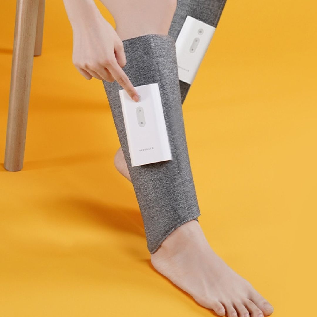 "Heated leg massager wraps around calves and ankles, shown in use. Provides soothing heat and customizable massage for relaxa