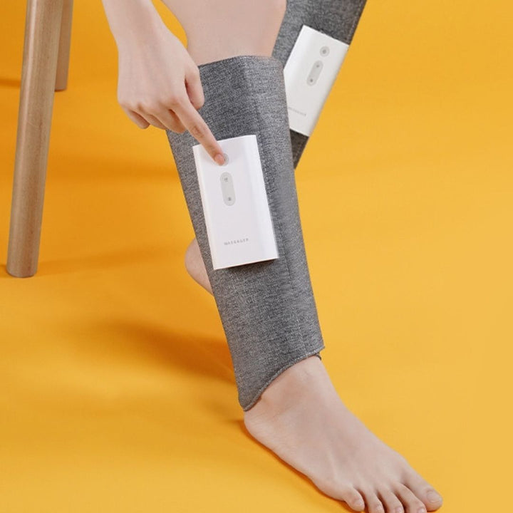 "Heated leg massager wraps around calves and ankles, shown in use. Provides soothing heat and customizable massage for relaxa