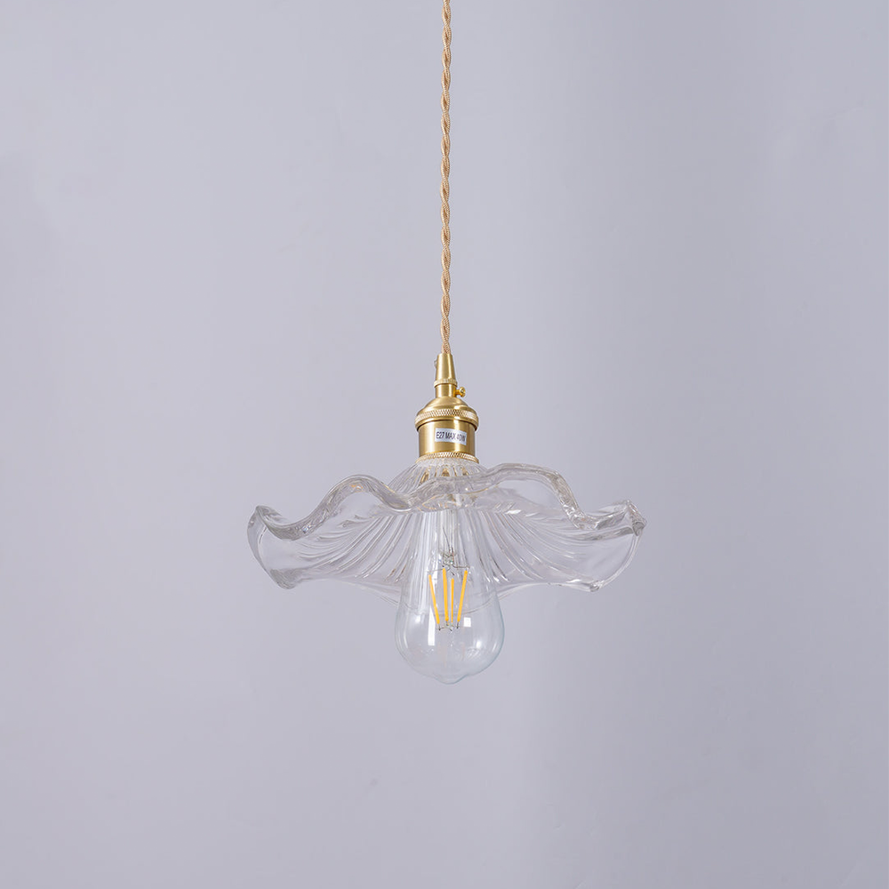 "Hibiscus flower-shaped pendant light in brass and glass, adds elegance and vibrancy to stylish room decor."