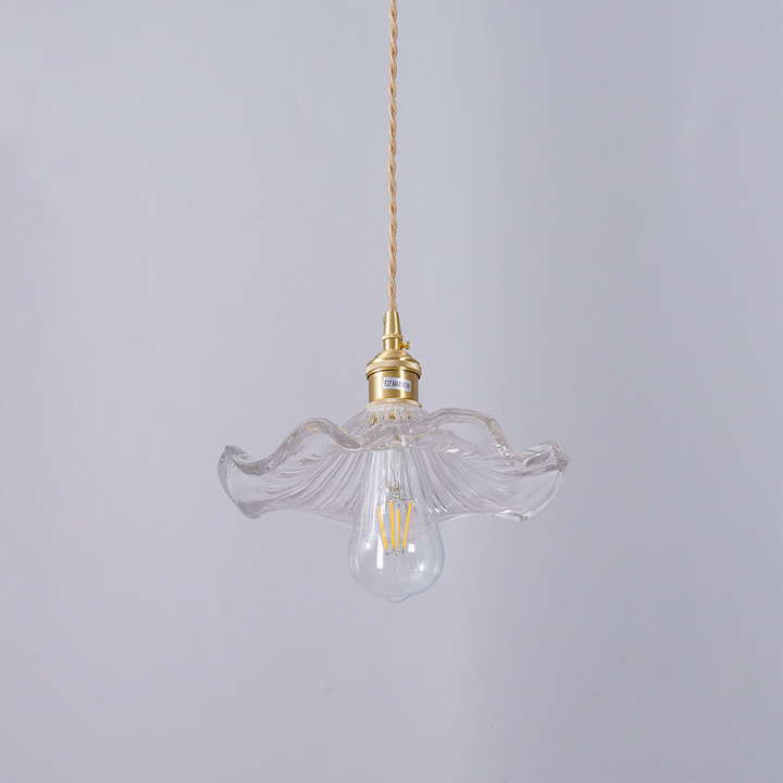 "Hibiscus flower-shaped pendant light in brass and glass, adds elegance and vibrancy to stylish room decor."