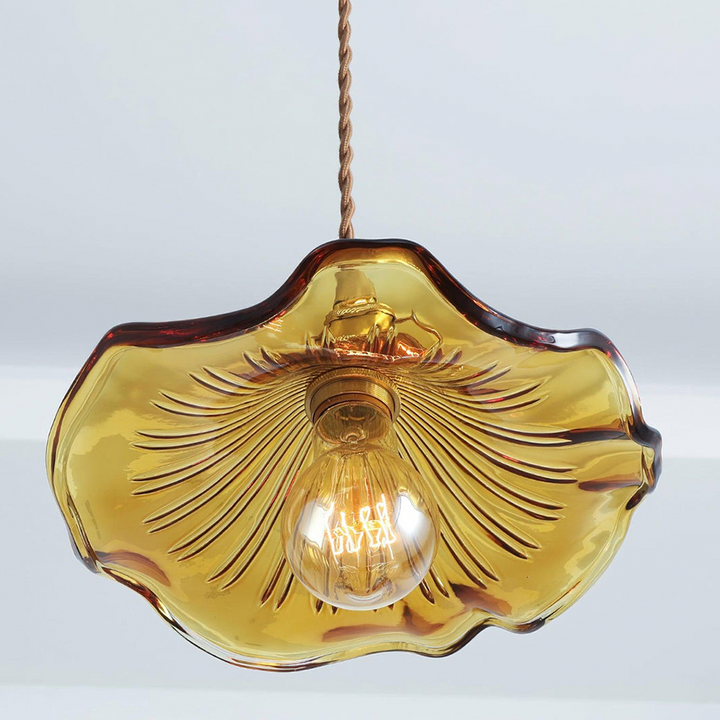 "Hibiscus flower-shaped pendant light in brass and glass, adds elegance and vibrancy to stylish room decor."